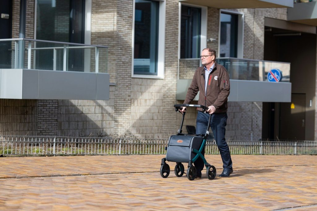 a man pushing a cart with a suitcase on it