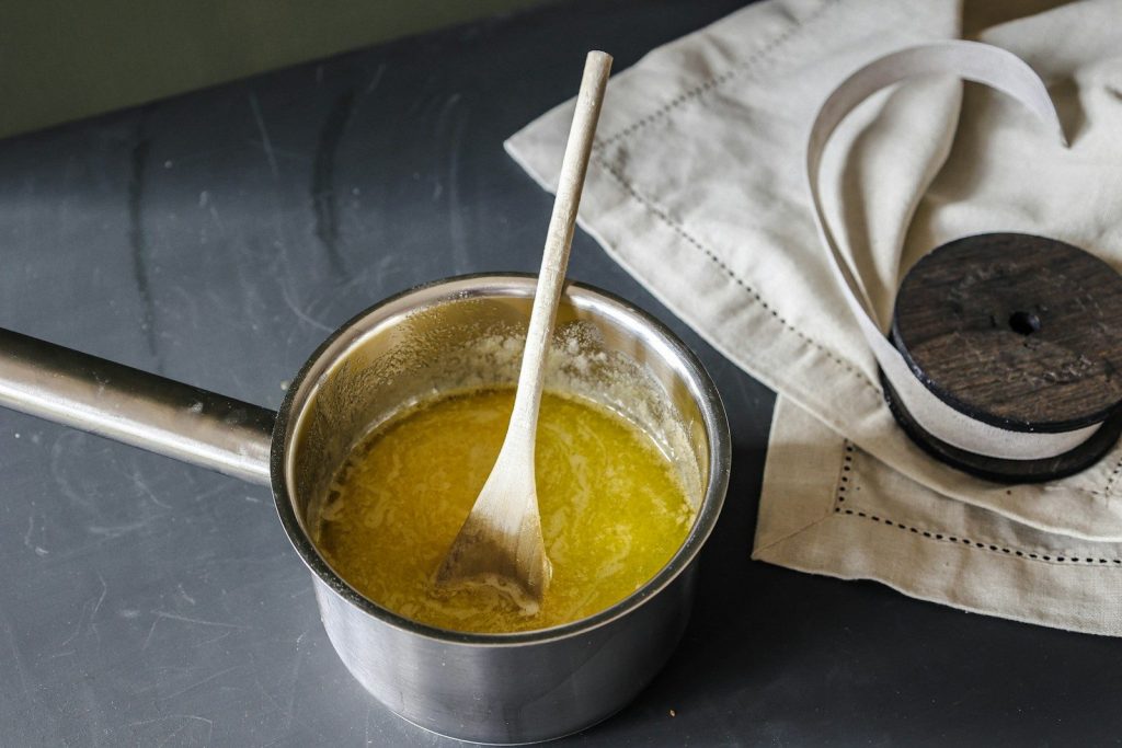 a metal cup with a spoon inside of it