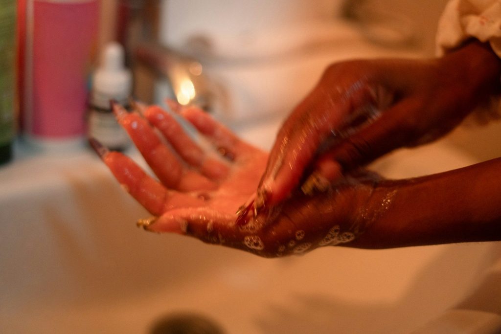 A person washing their hands with soap and water.