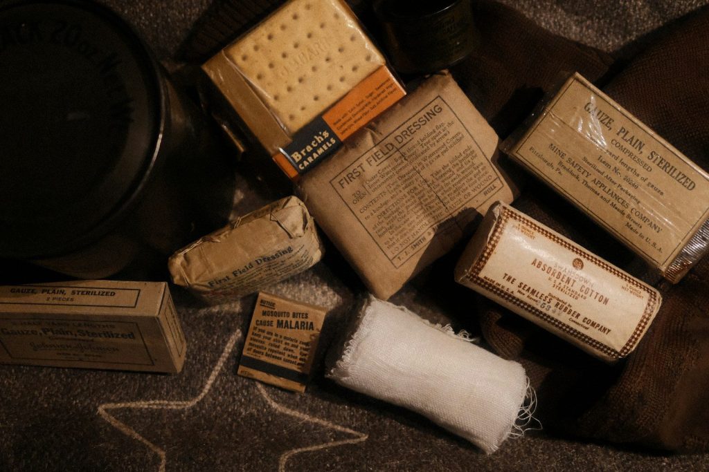 Assortment of vintage military rations and medical supplies.