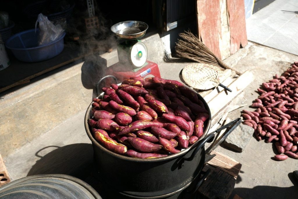 a bucket full of red potatoes sitting on top of a table