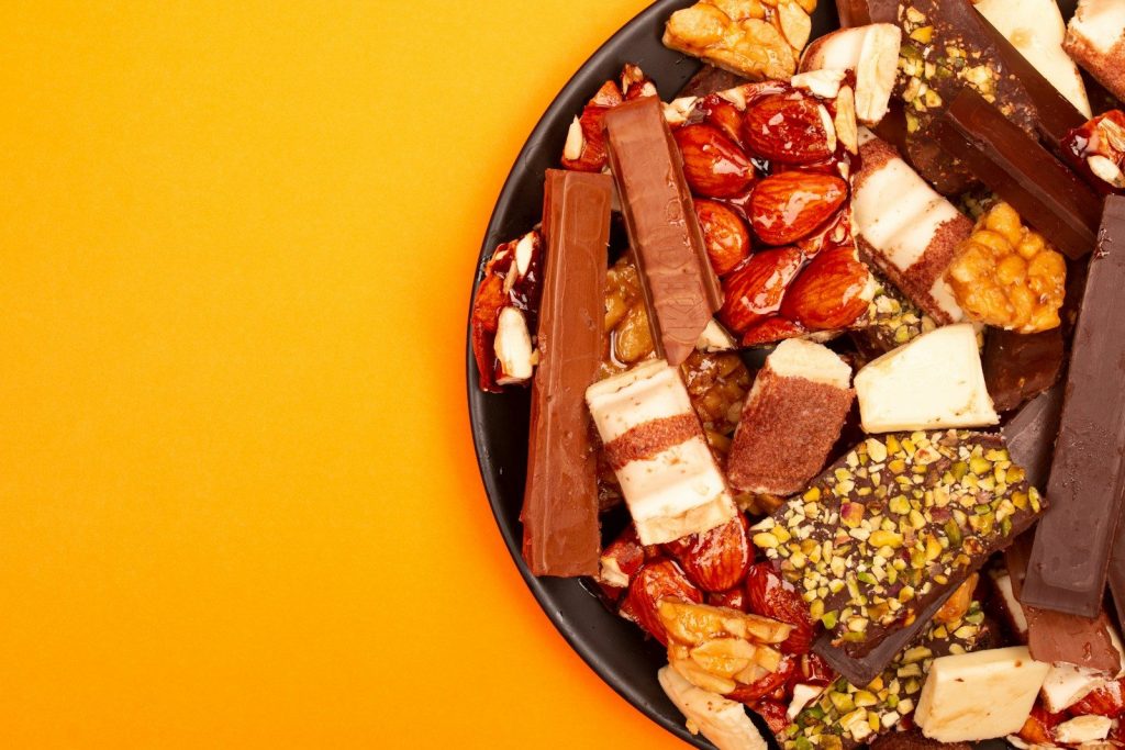 Assortment of chocolate bars and nuts on a plate