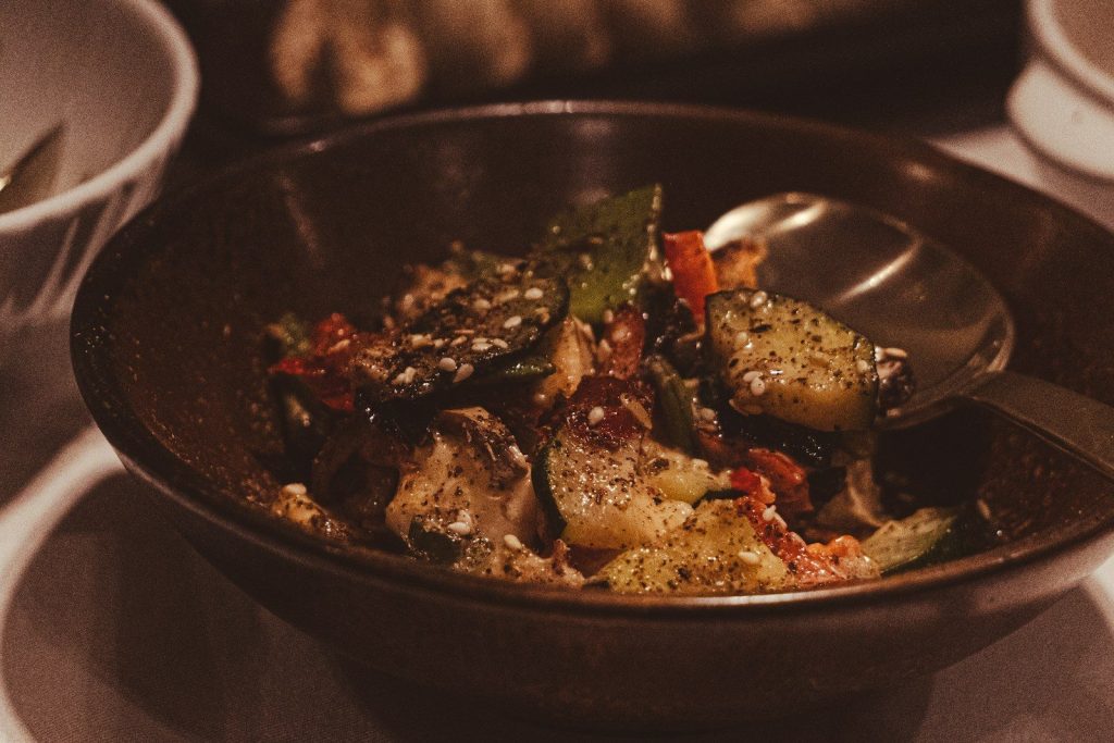 Bowl of mixed roasted vegetables with sesame seeds