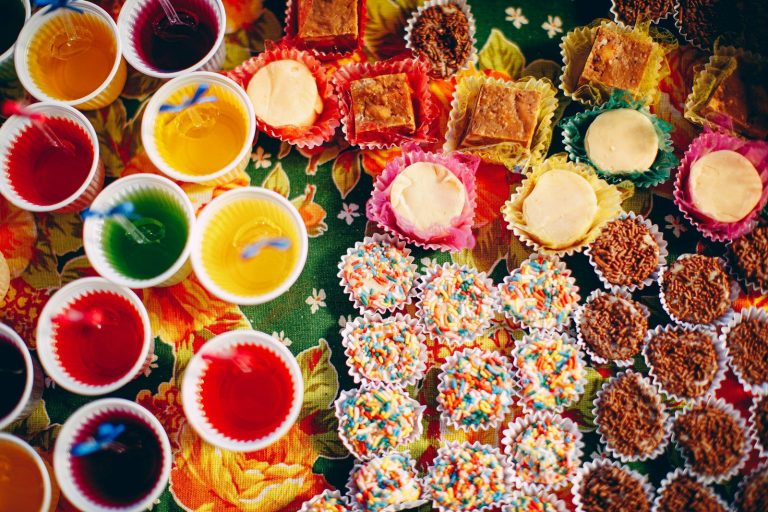 assorted color of candies on brown wooden table