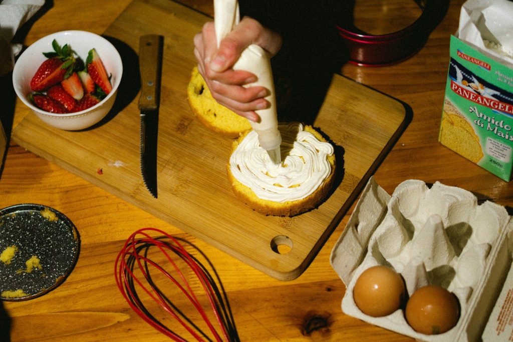 a person is spreading icing on a piece of bread