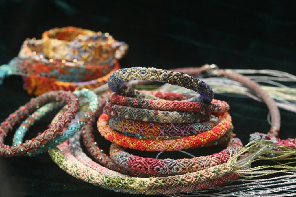 Stack of colorful woven bracelets with fringe details