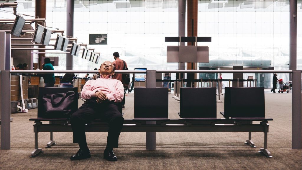 person sleeping on gang chair
