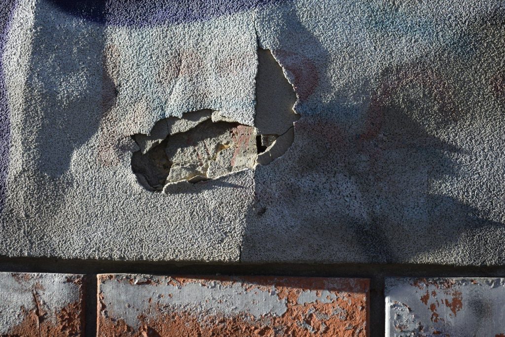 a brick wall with a crack in the middle of it