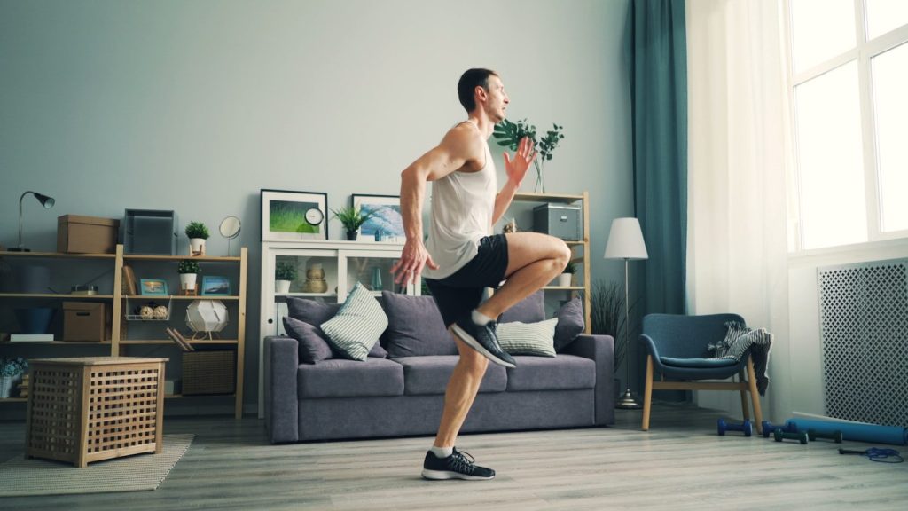 a man is dancing in a living room