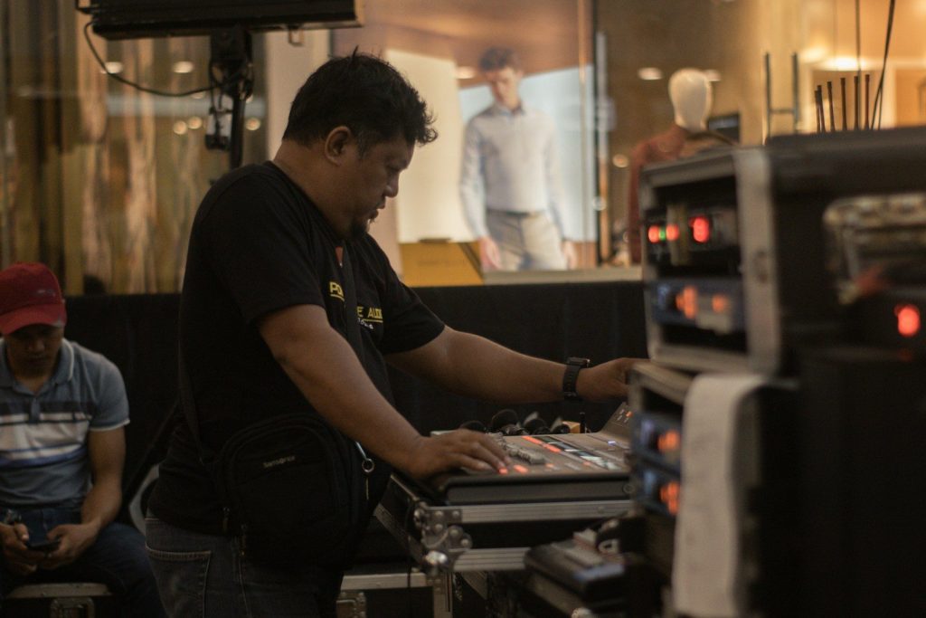 a man sitting at a table working on a laptop