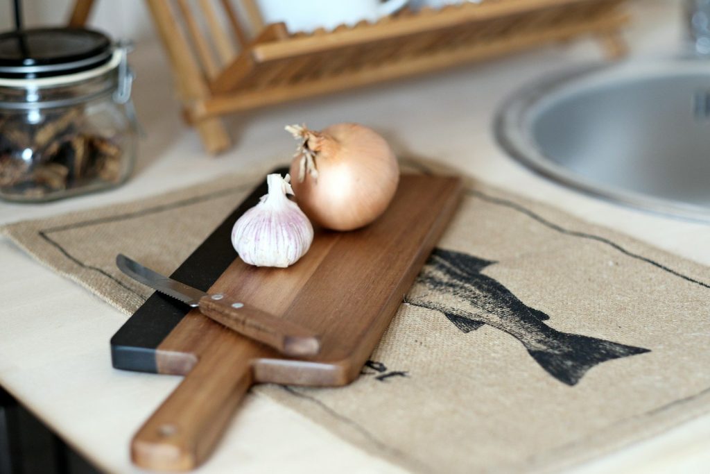 a knife and a garlic on a cutting board