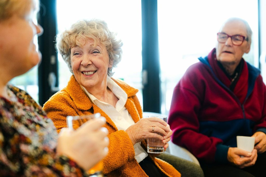 Three seniors talking and smiling together