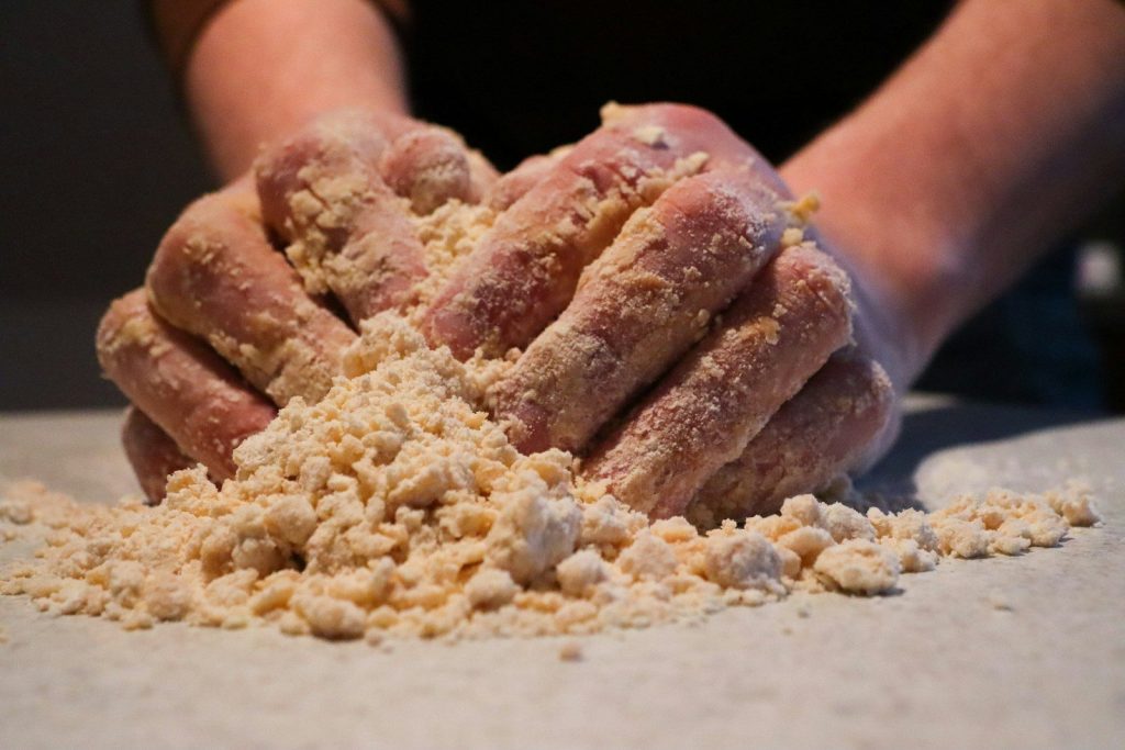 a person holding a pile of food in their hands