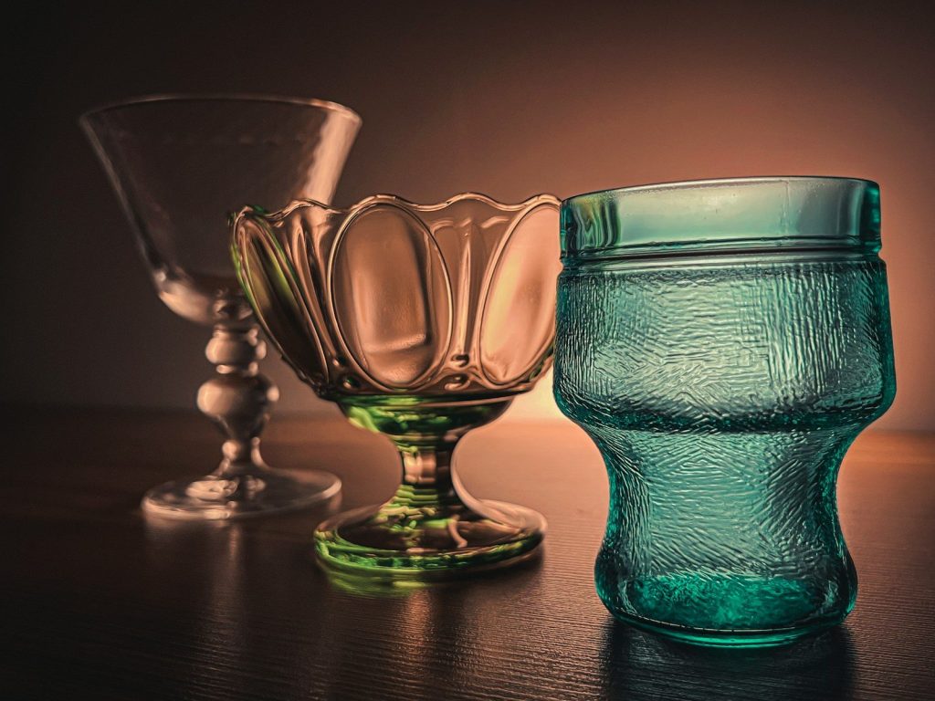 a couple of glass vases sit on a table