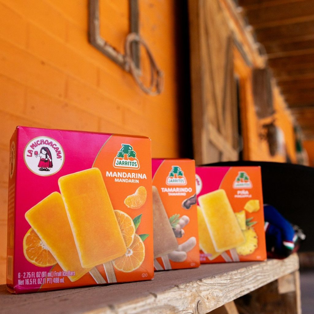 three boxes of orange juice sitting on a table