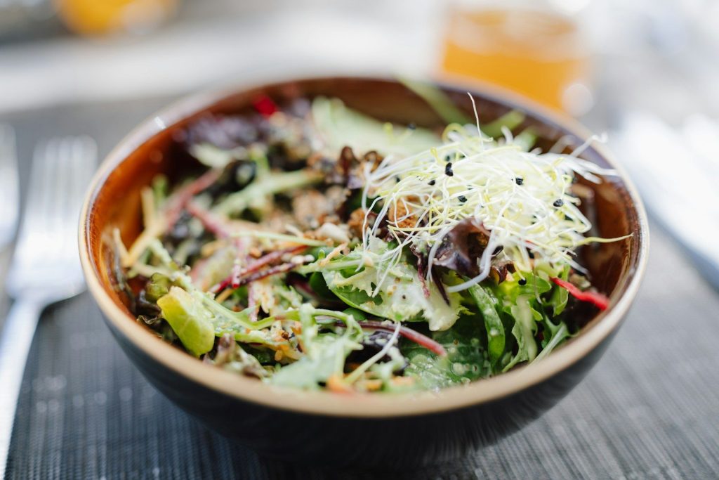 Fresh salad in a rustic bowl with sprouts