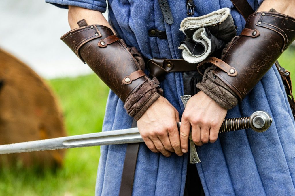 a close up of a person holding a sword