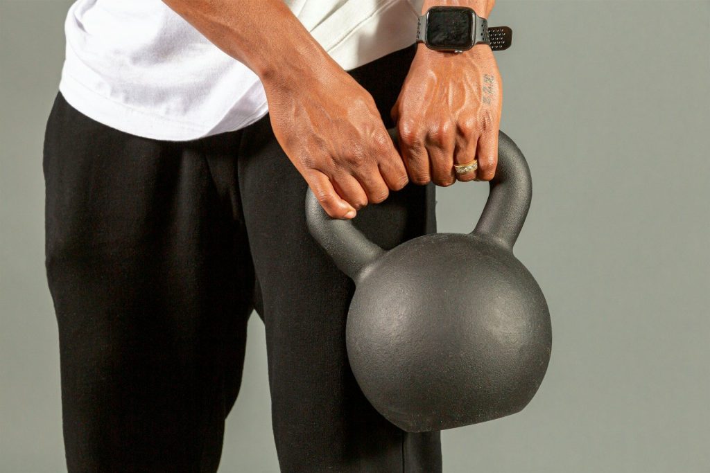 a man holding a kettle with both hands