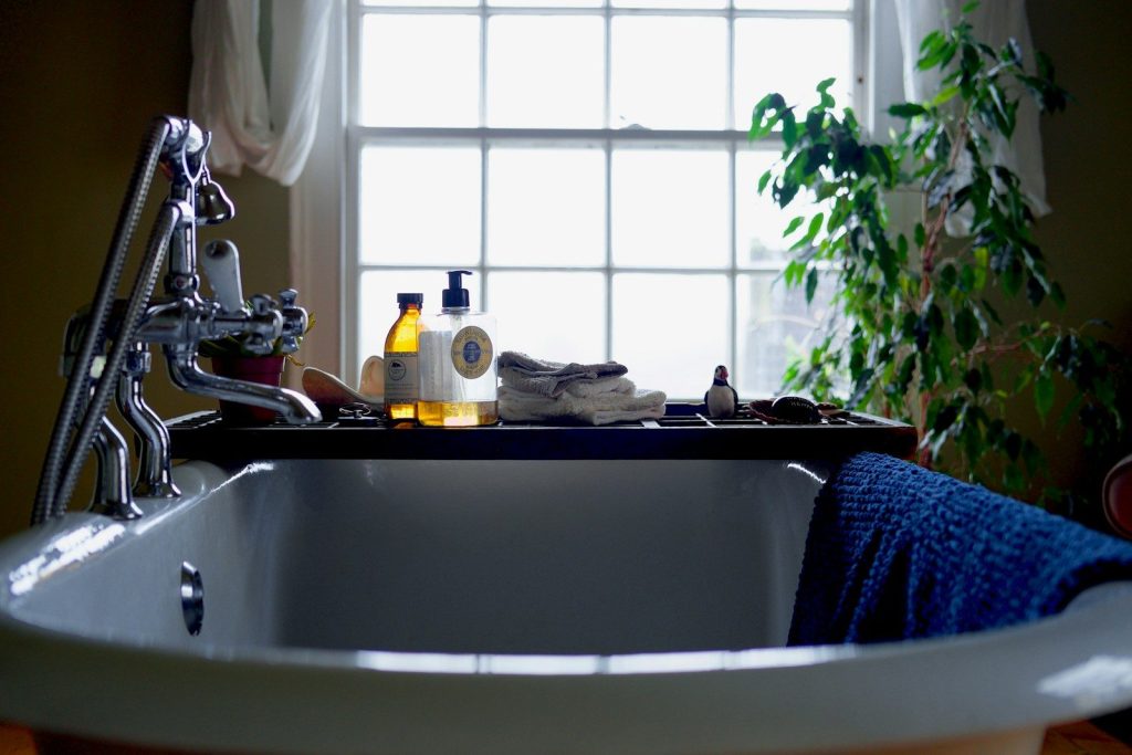 white ceramic bathtub with stainless steel faucet
