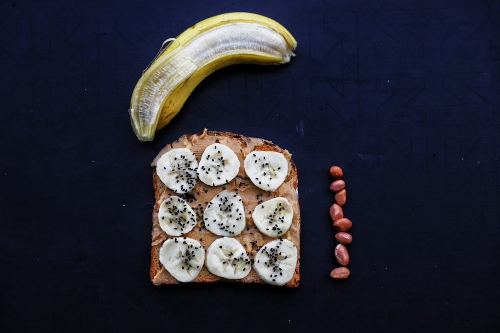 a piece of bread with bananas and nuts on it