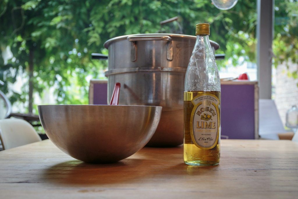 a bottle of wine and a bowl on a table