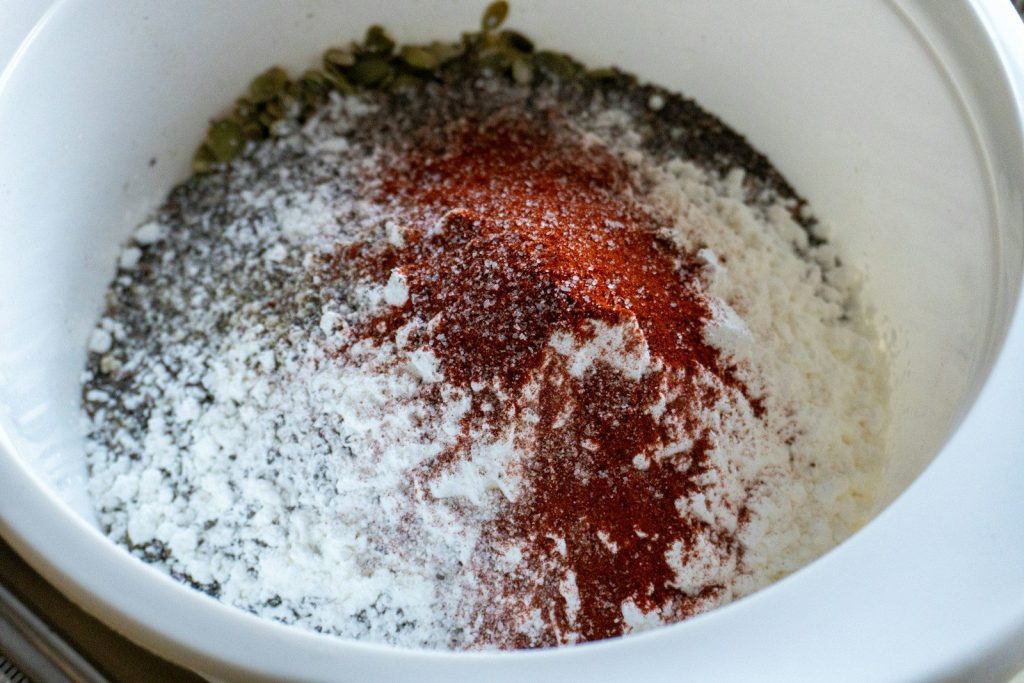 Spices and flour mixed in a white bowl.