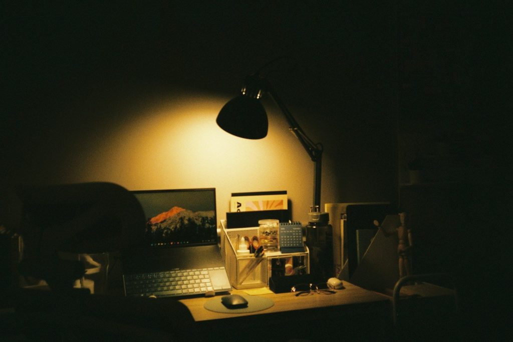 a laptop computer sitting on top of a wooden desk