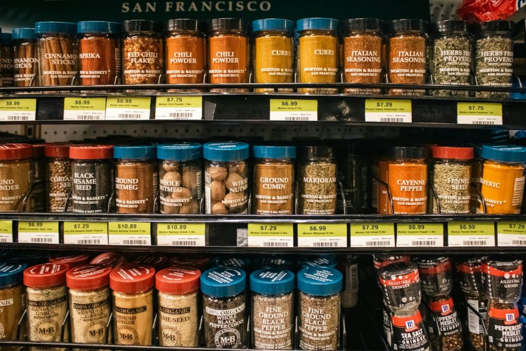 Shelves of various spice jars are displayed.