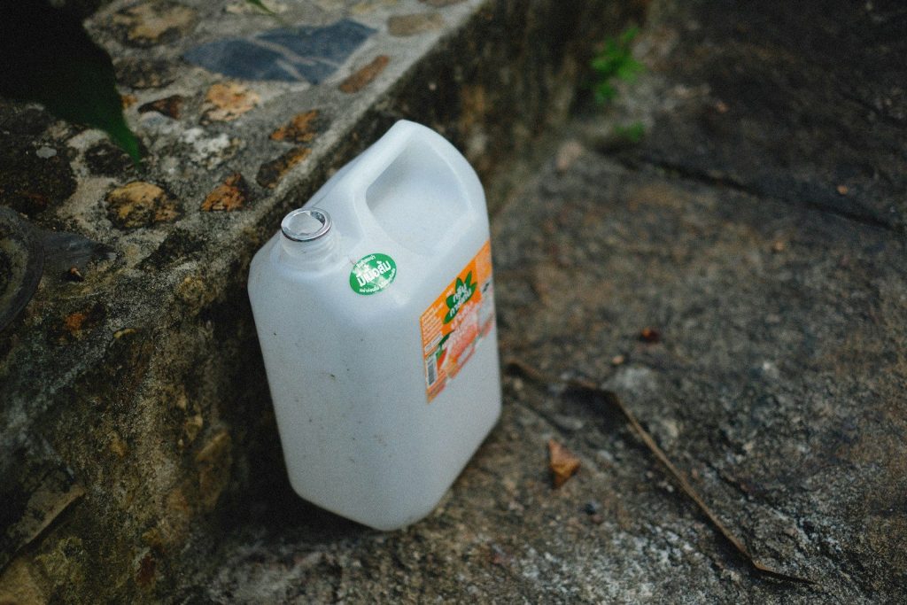 a gallon of milk sitting on the ground