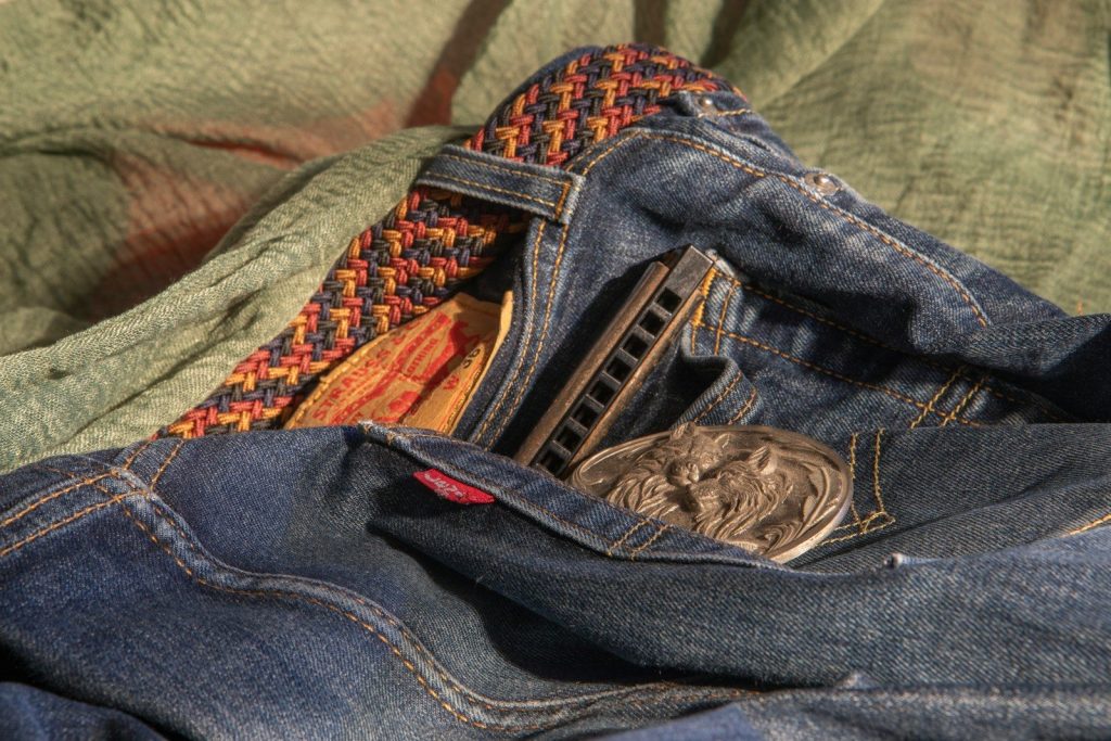 Jeans, belt, and harmonica.