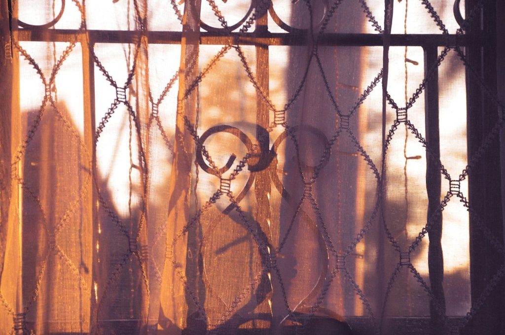 A close up of a window with a curtain