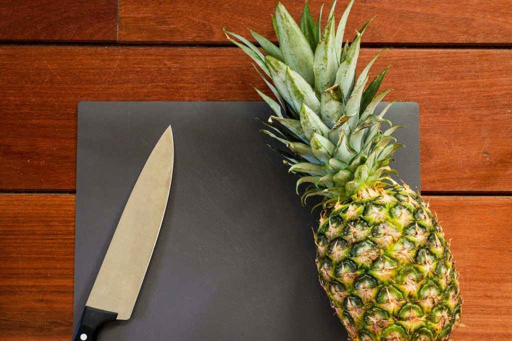 green pineapple fruit on black leather textile