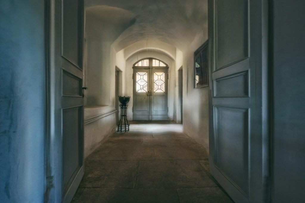 a hallway with a door and windows