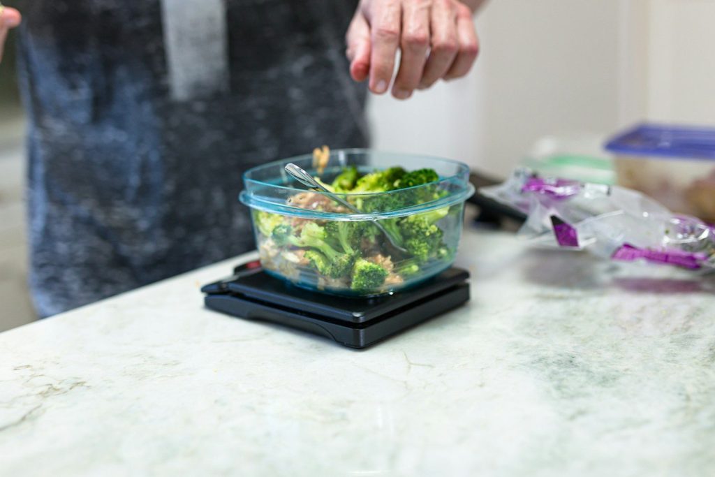 green and black plastic container on white table