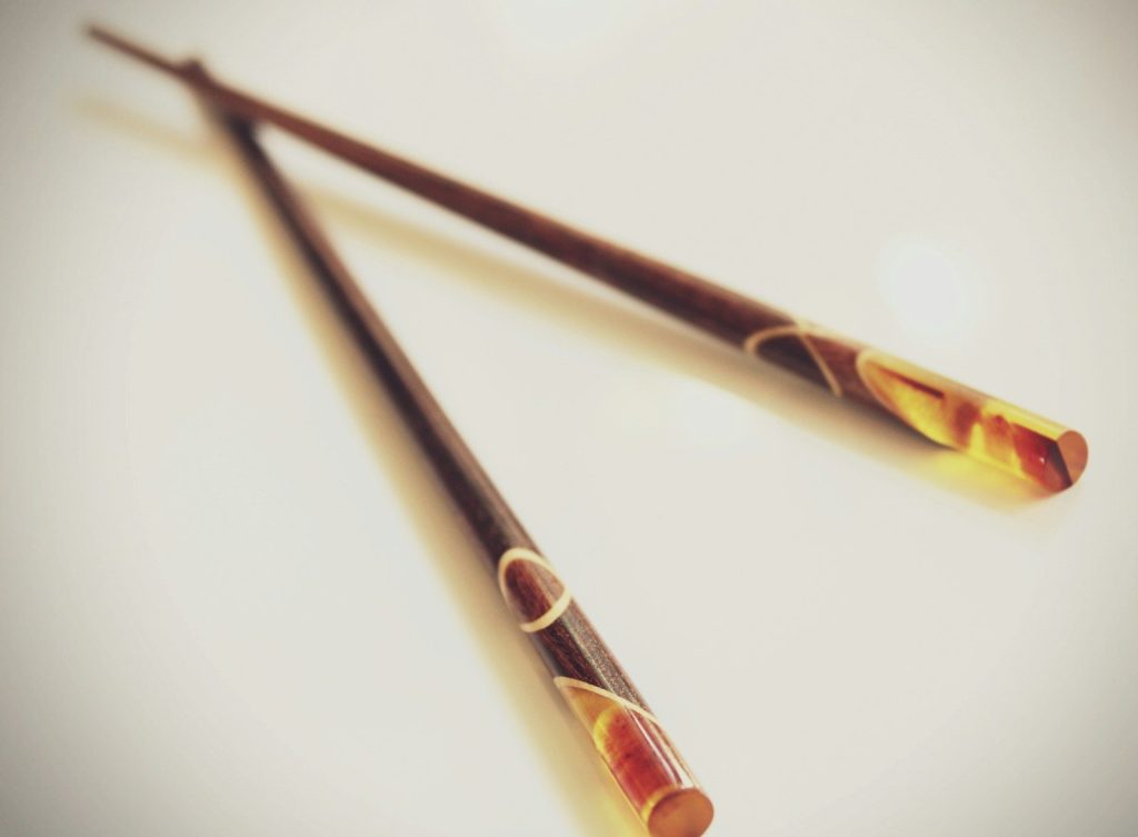 a pair of chopsticks sitting on top of a table