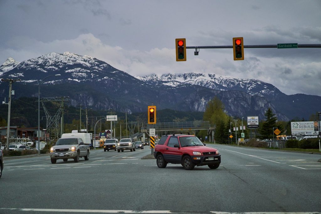 a red truck driving down the street