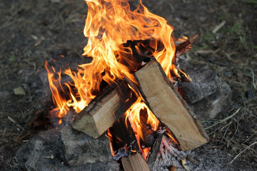 a close up of a fire burning in a field