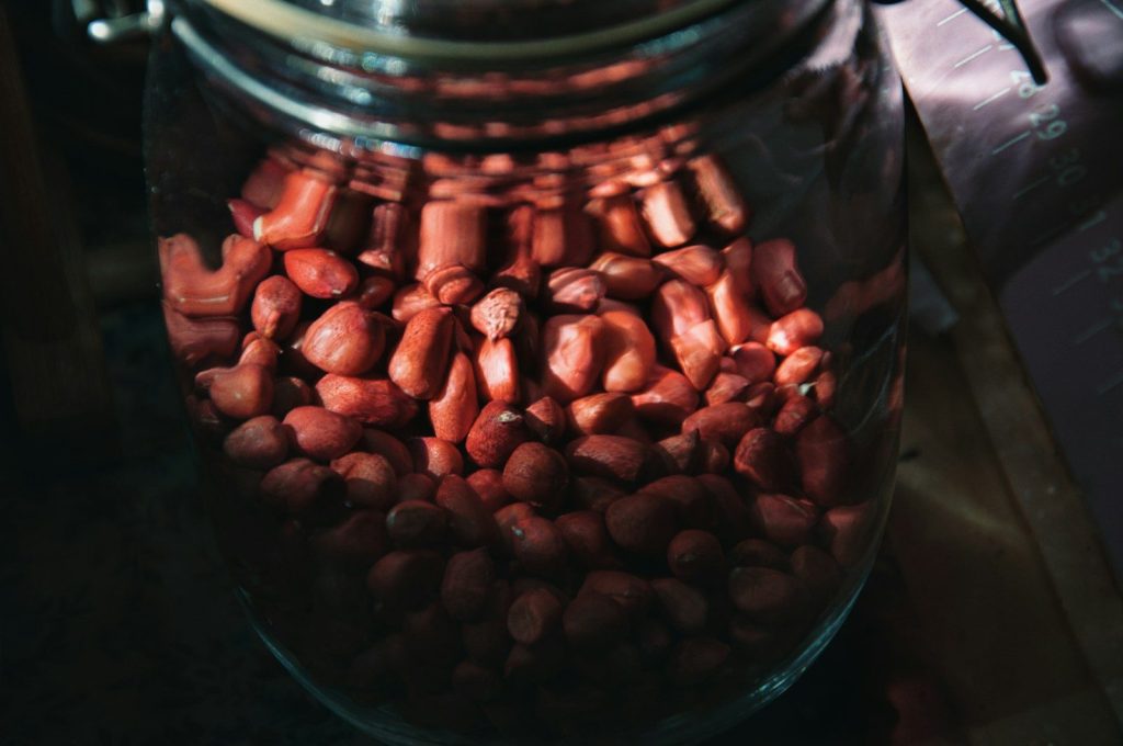 a jar filled with red beans sitting on top of a table