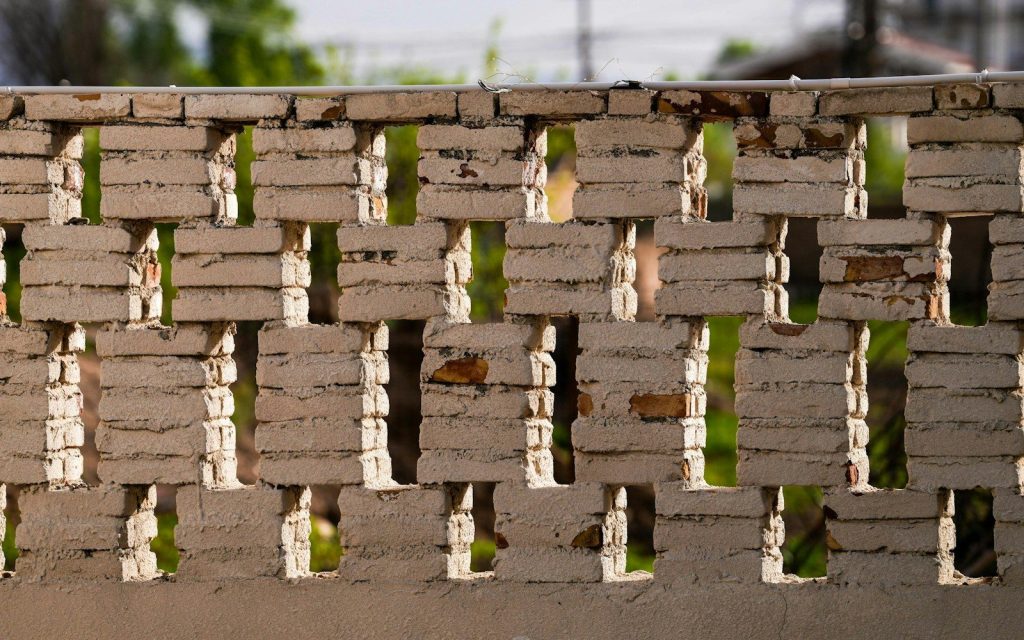 A close up of a fence made of bricks