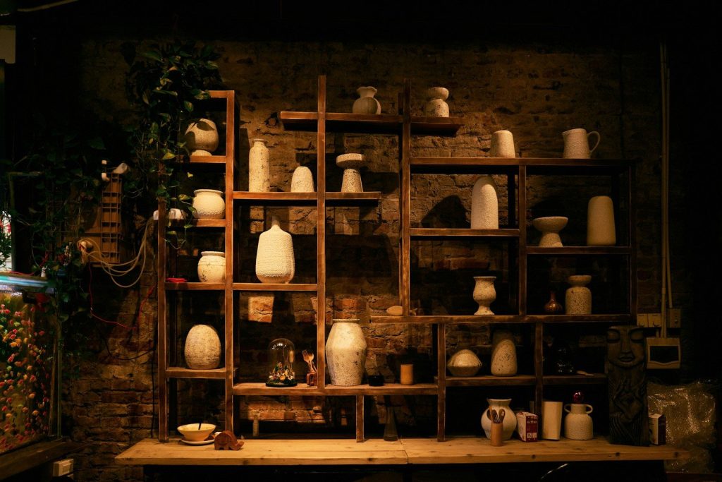 Shelves filled with various ceramic vases and pots.