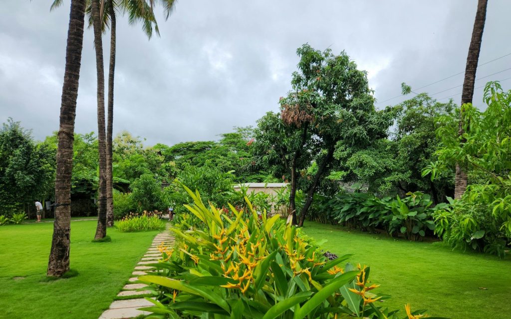 A green garden path leads to the distance.
