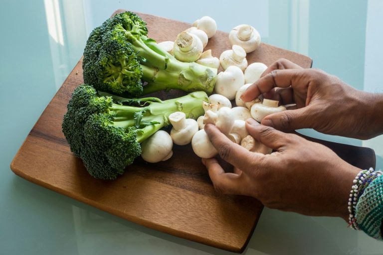 white garlic on brown wooden chopping board