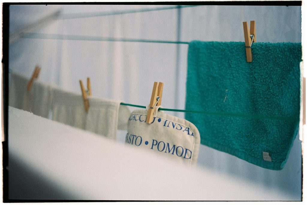Towels hanging on a clothesline with clothespins.
