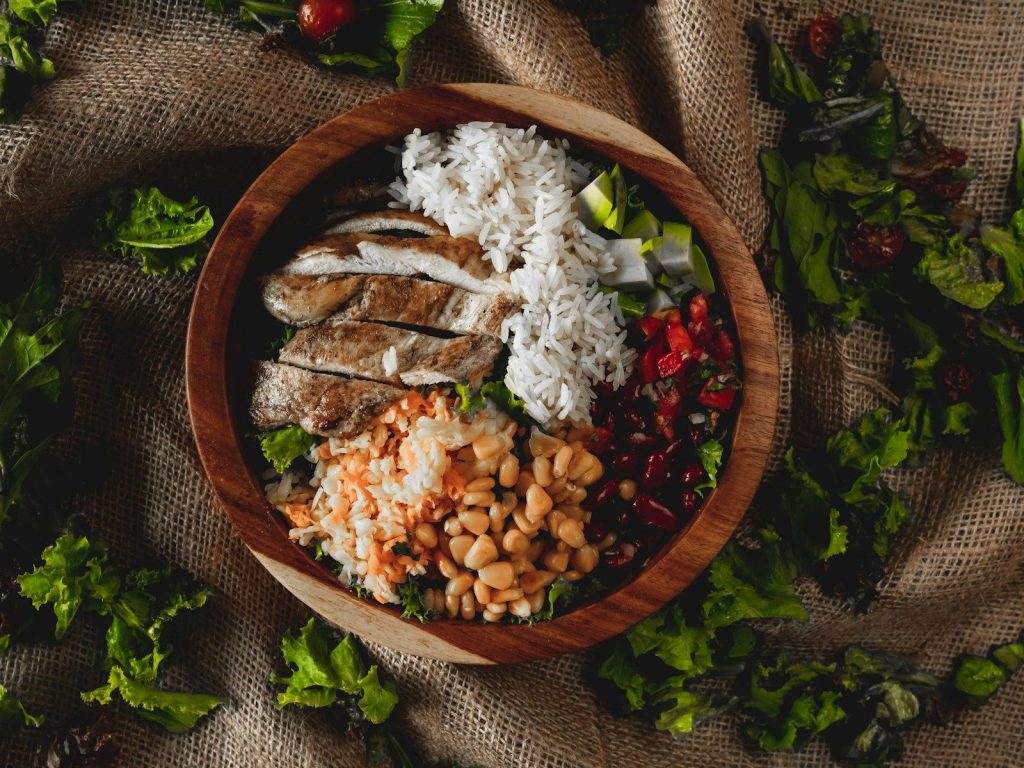 Sliced grilled chicken with rice and beans