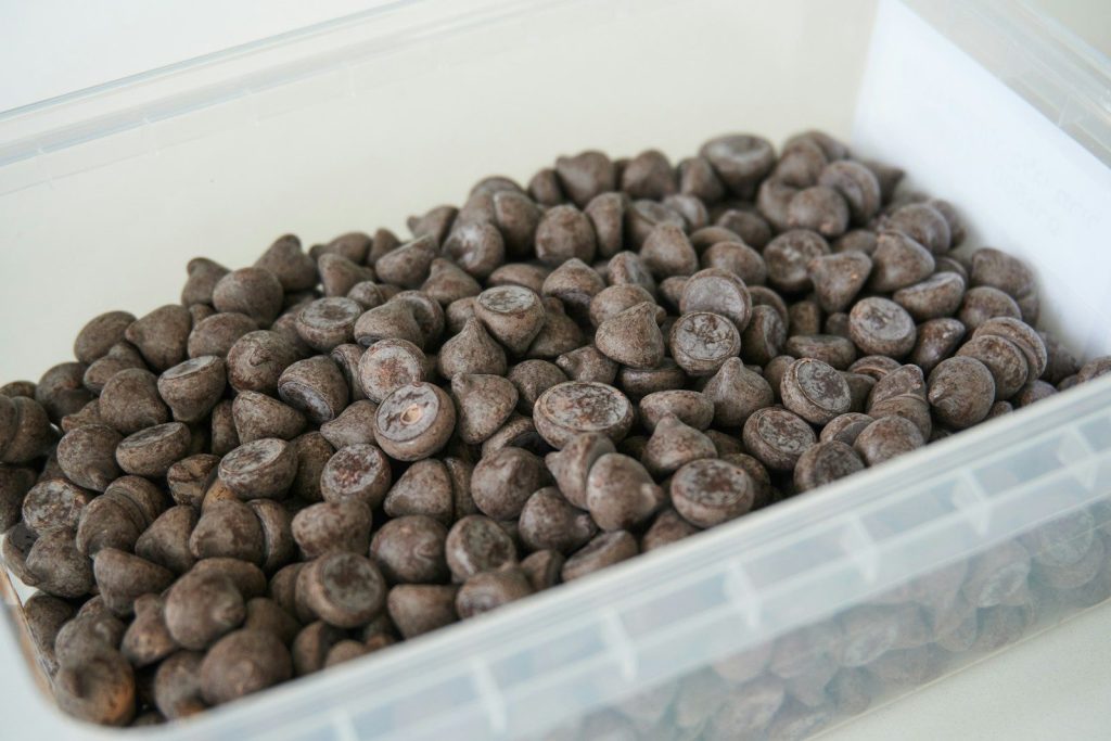 brown coffee beans on white plastic container