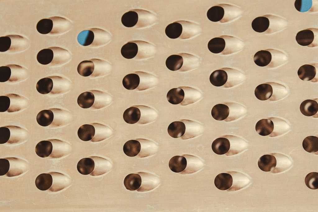 a close up of a metal grate with holes