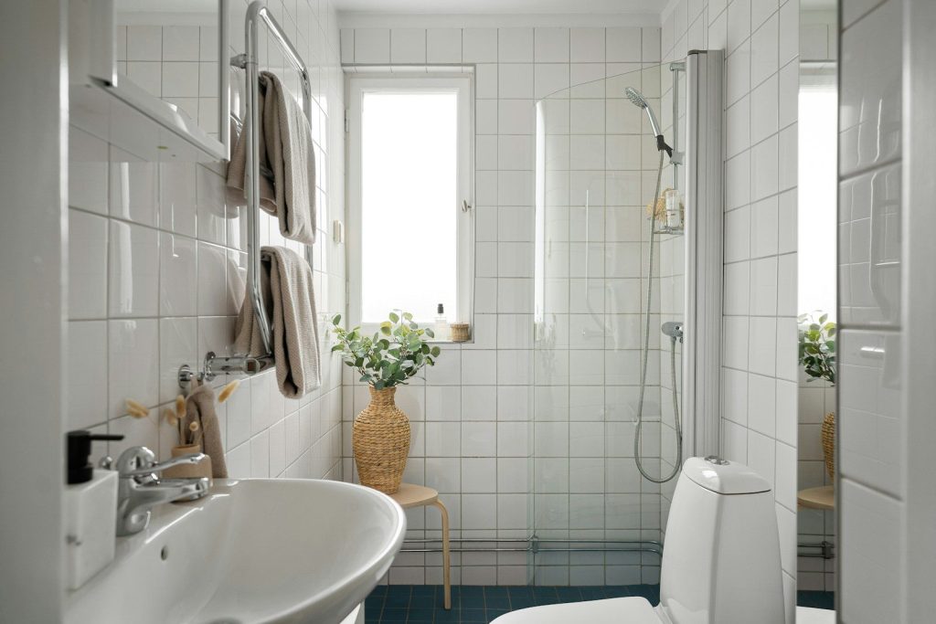 A bathroom with a toilet, sink, and shower