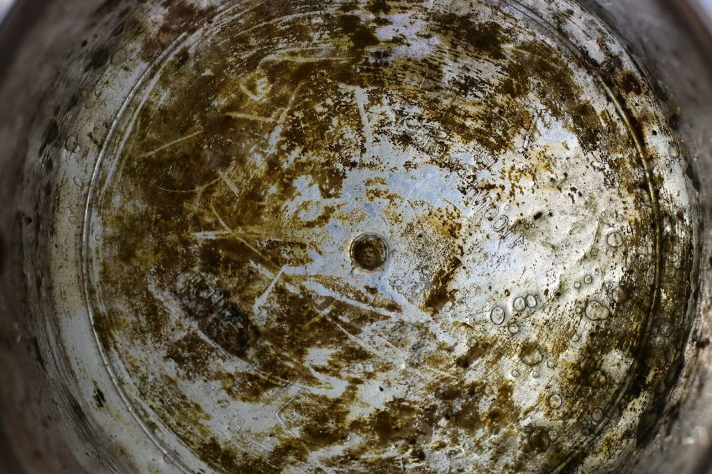 The inside of a dirty bucket is shown.