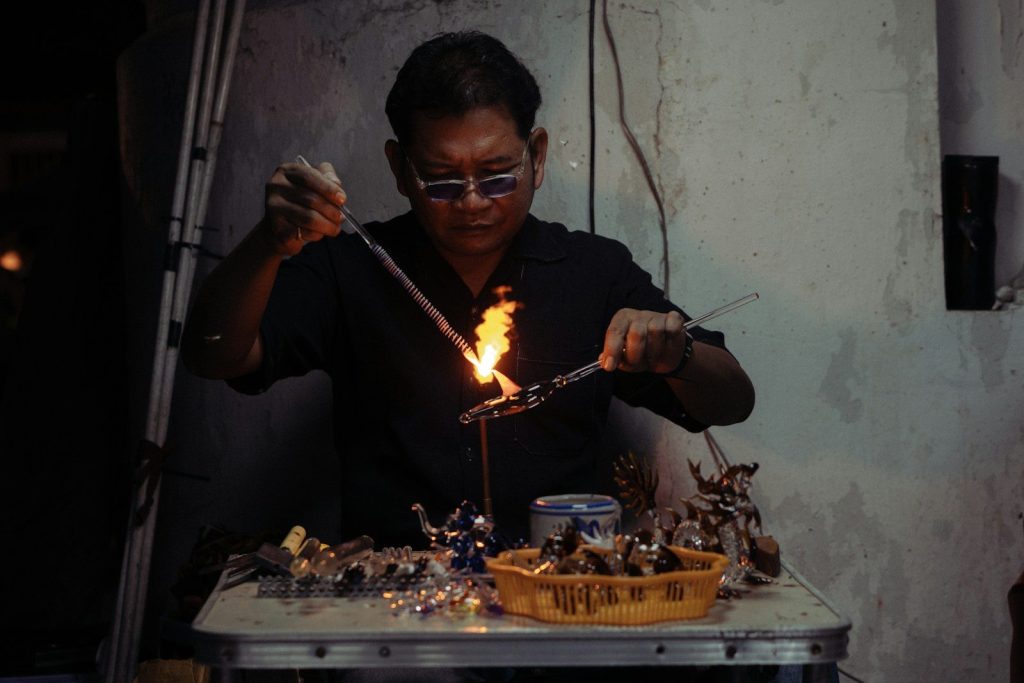 Man working with hot glass and flame