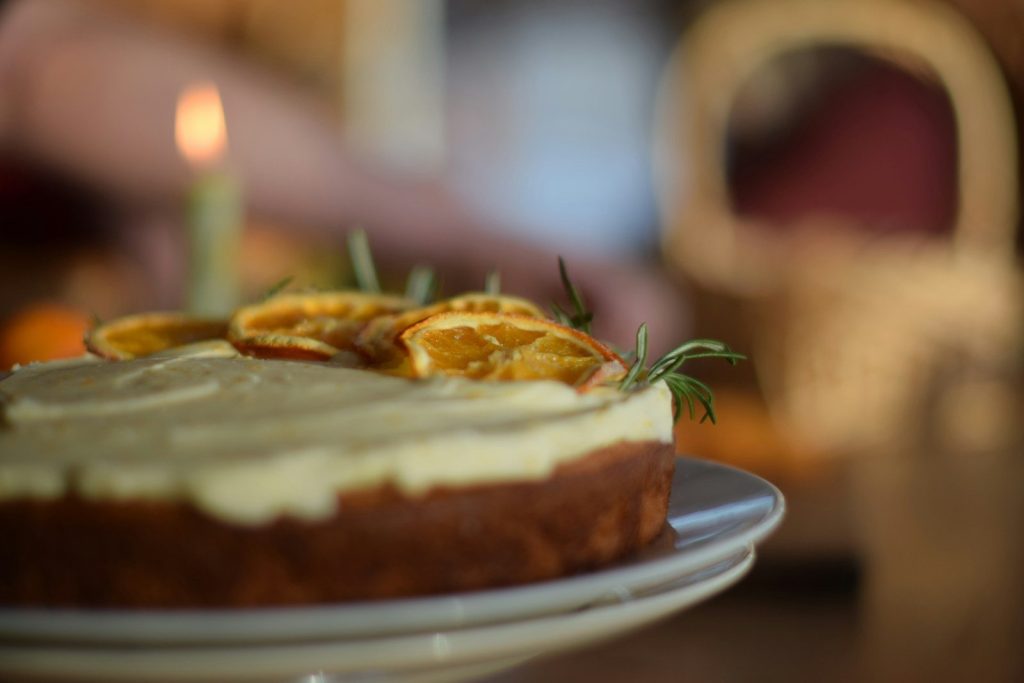 Cake with dried orange slices and rosemary garnish
